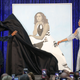 Former U.S. first lady Michelle Obama (L) and artist Amy Sherald unveil her portrait during a ceremony at the Smithsonian’s National Portrait Gallery, on February 12, 2018 in Washington, DC.